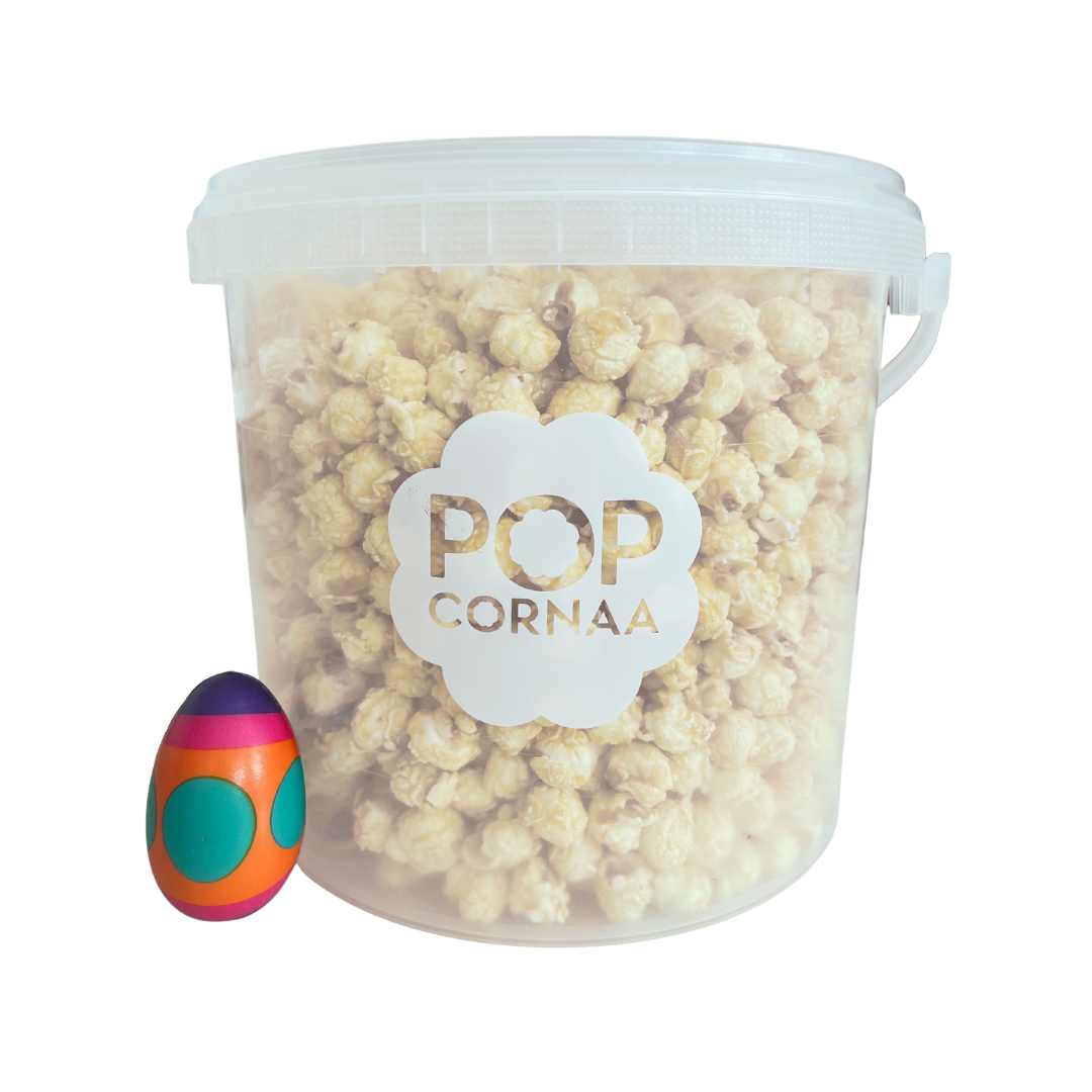 Bucket of 100% clean, dairy free Seaweed, Wasabi x Soy popcorn with 'Pop Cornaa' label and a colorful egg-shaped object on a white background