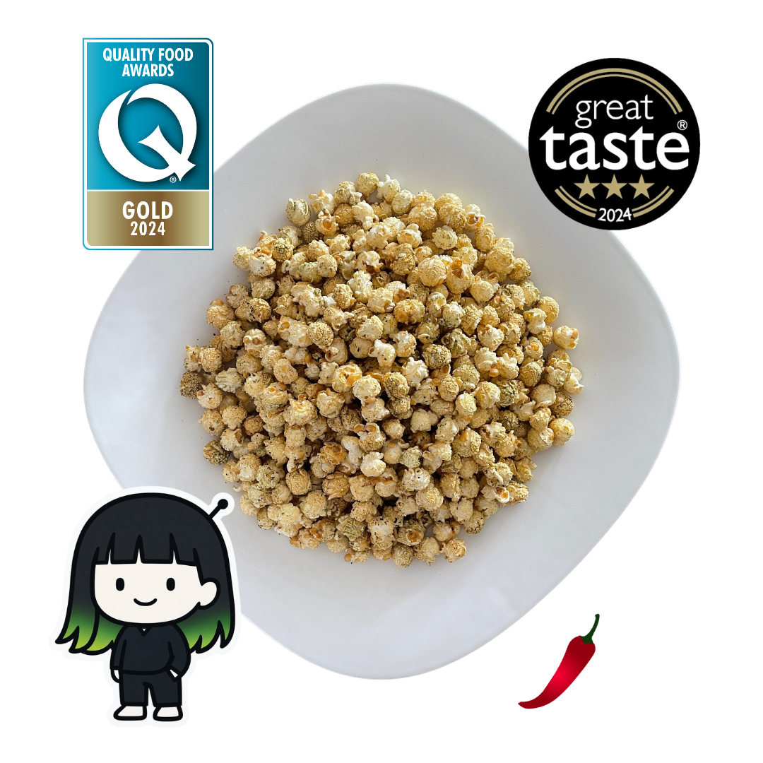 PopCornaa plate with Seaweed, Wasabi  x Soy Popcorn , 'Great Taste' award logo, 'Quality Food Awards' gold 2024 badge, cartoon character, and red chili pepper on a white background.