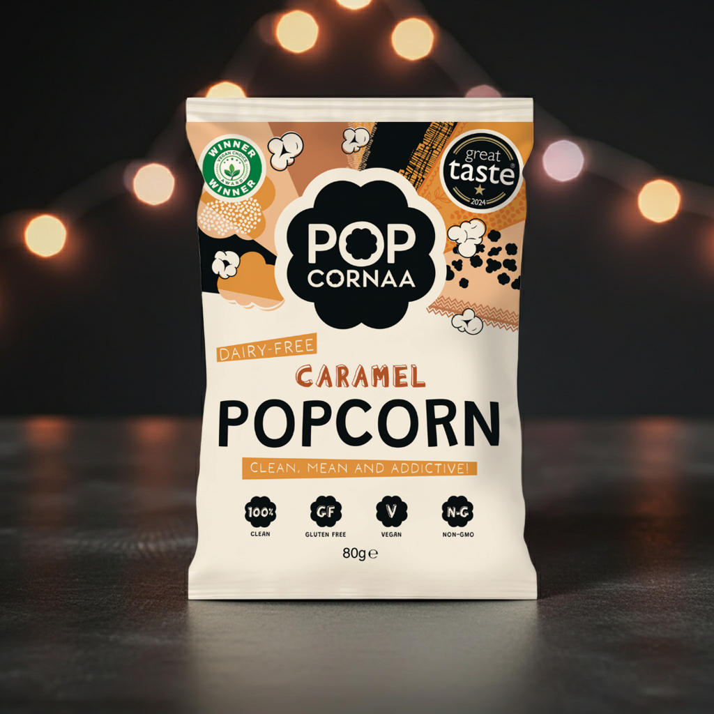 Packaging of Pop Cornaa Caramel Popcorn with decorative lights in the background