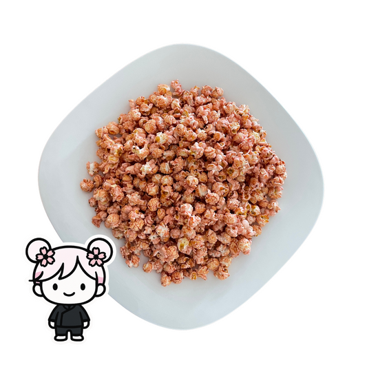 PopCornaa Pink Litchi x Strawbibi popcorn on a white plate with a cartoon character icon in the corner.