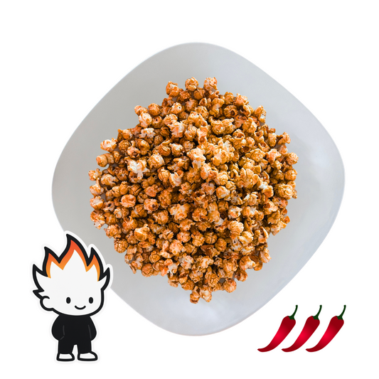 PopCornaa spicy Sriracha popcorn on a plate with cartoon character and three red peppers on a white background