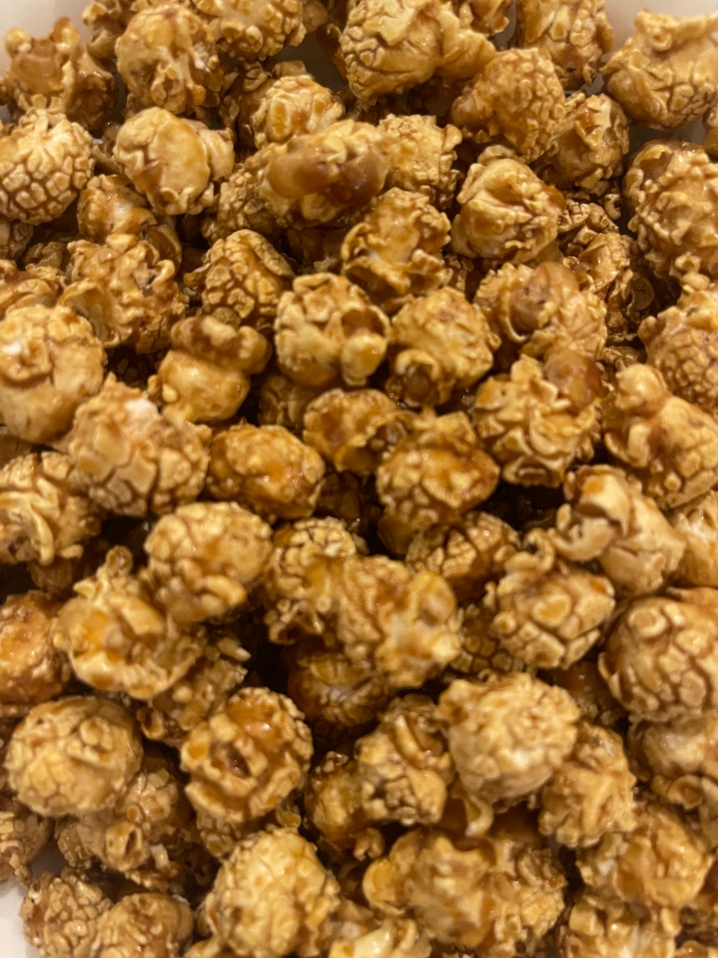 PopCornaa close-up of vegan dairy free 100% clean caramel popcorn on a white background