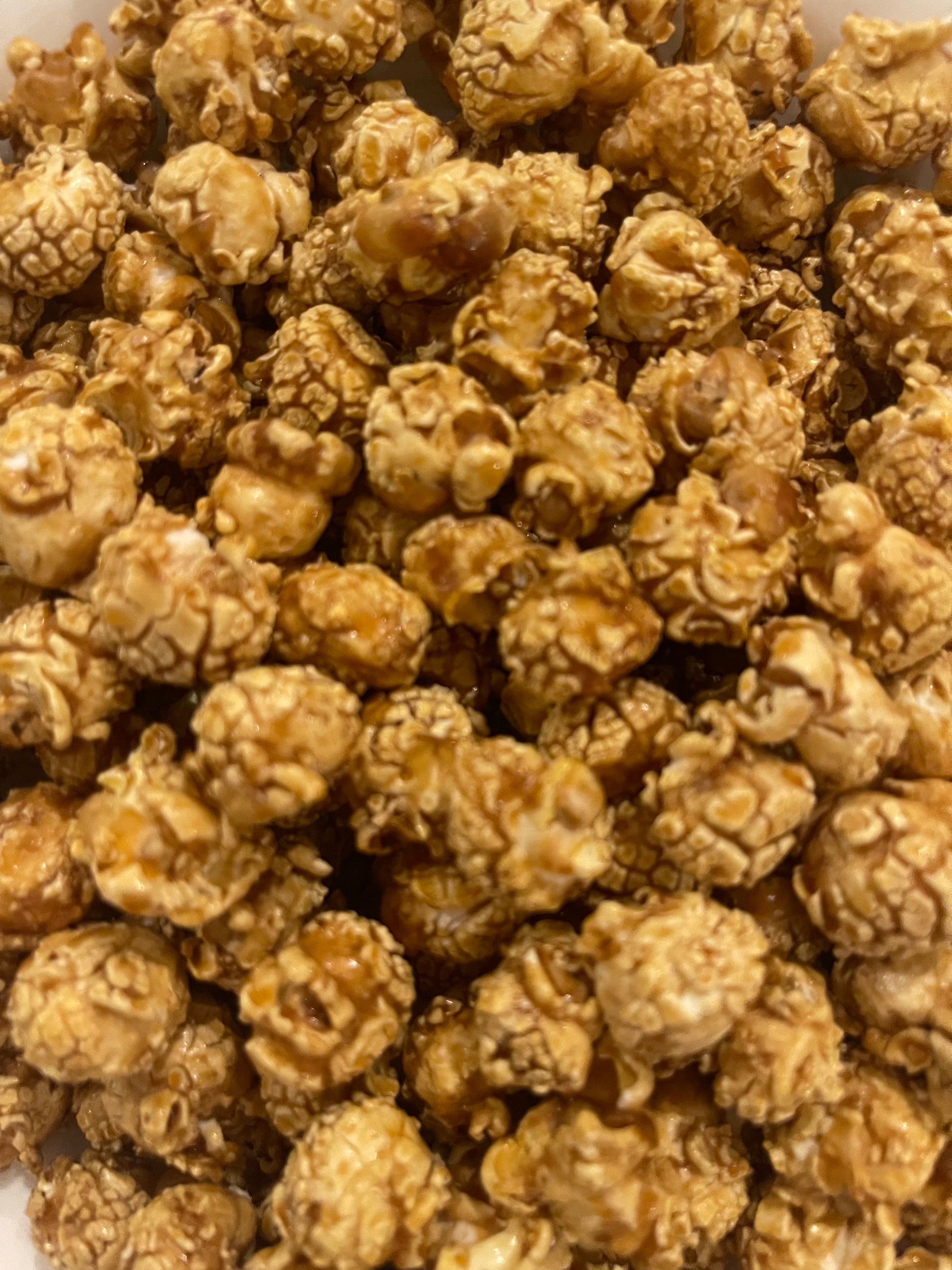 PopCornaa close-up of vegan dairy free 100% clean caramel popcorn on a white background